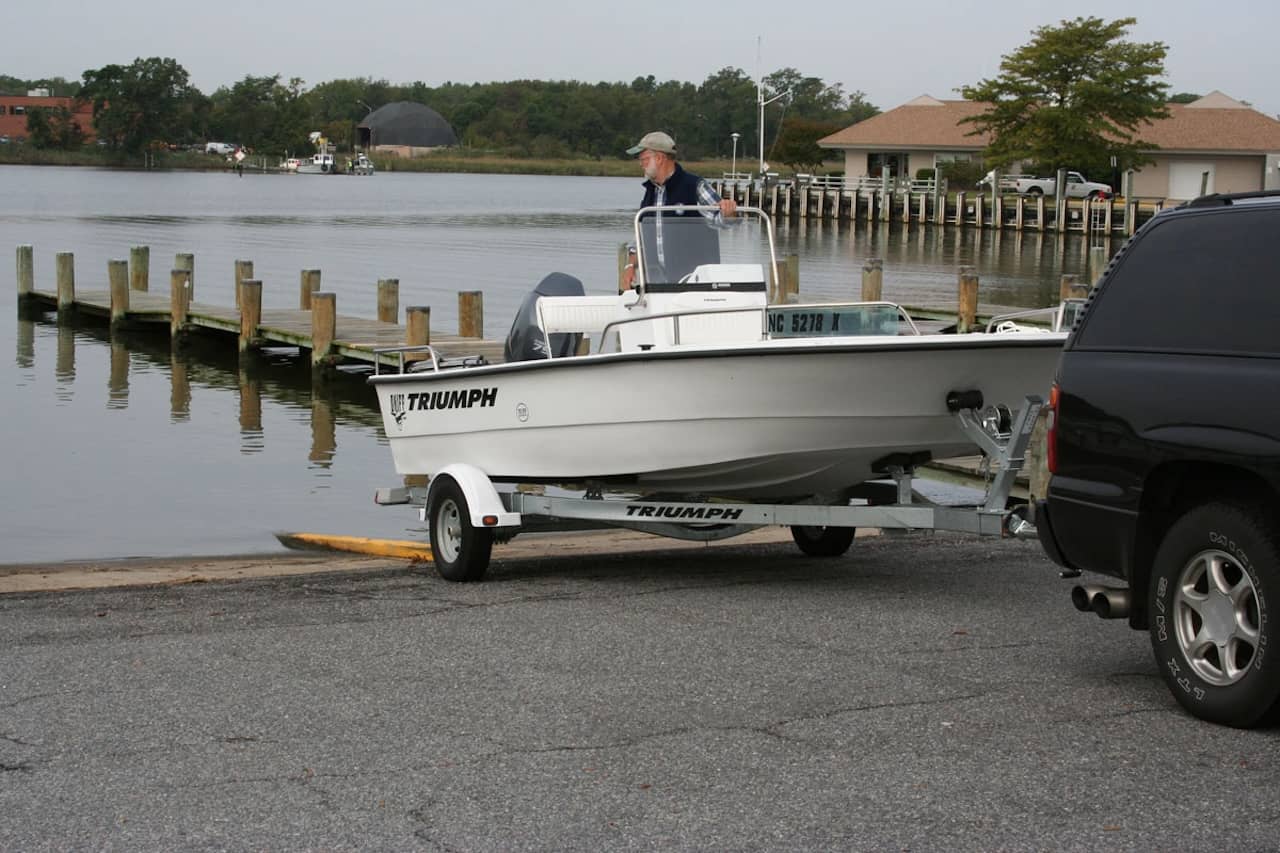 If your helper is a seasoned boater, you may want to have them board prior to launch and have them back the boat off the trailer under power.