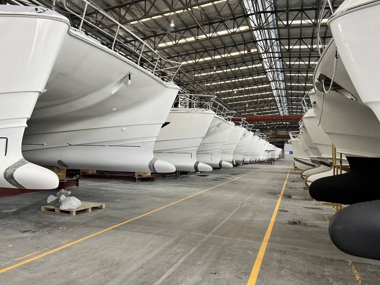 Featuring bulbous bows of glass and foam below the waterline, a row of Aquila 54Y and 50Y models face a lineup of 44Y and 42Y models at the Hangzhou, China factory.